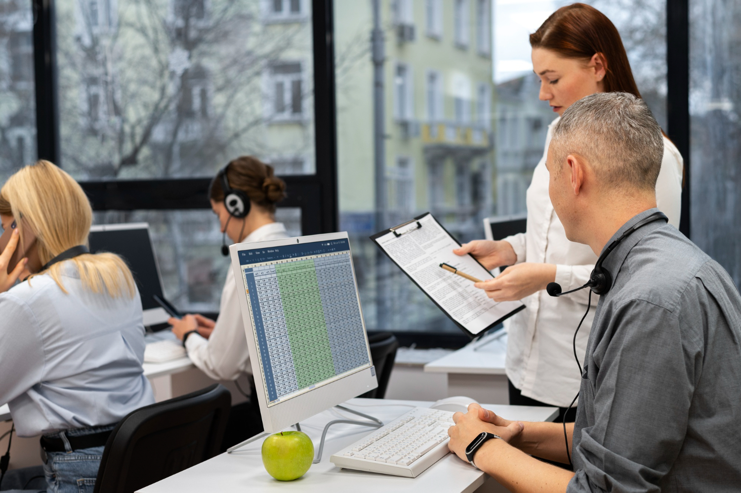 men with discussion over excel sheet with supervisor
